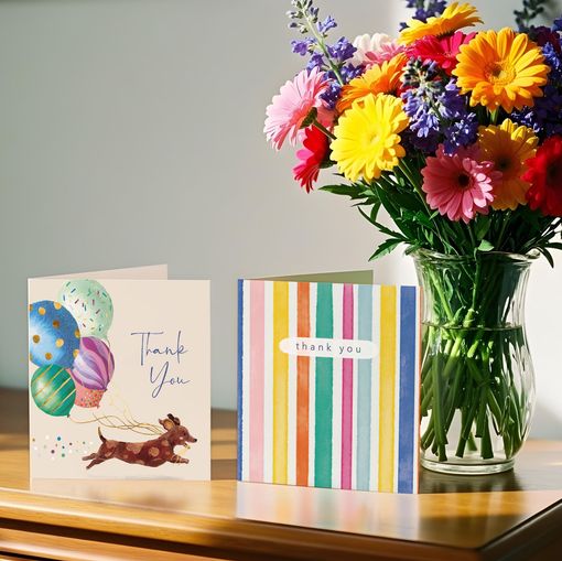 A bunch of cards are sitting on a wooden table.
