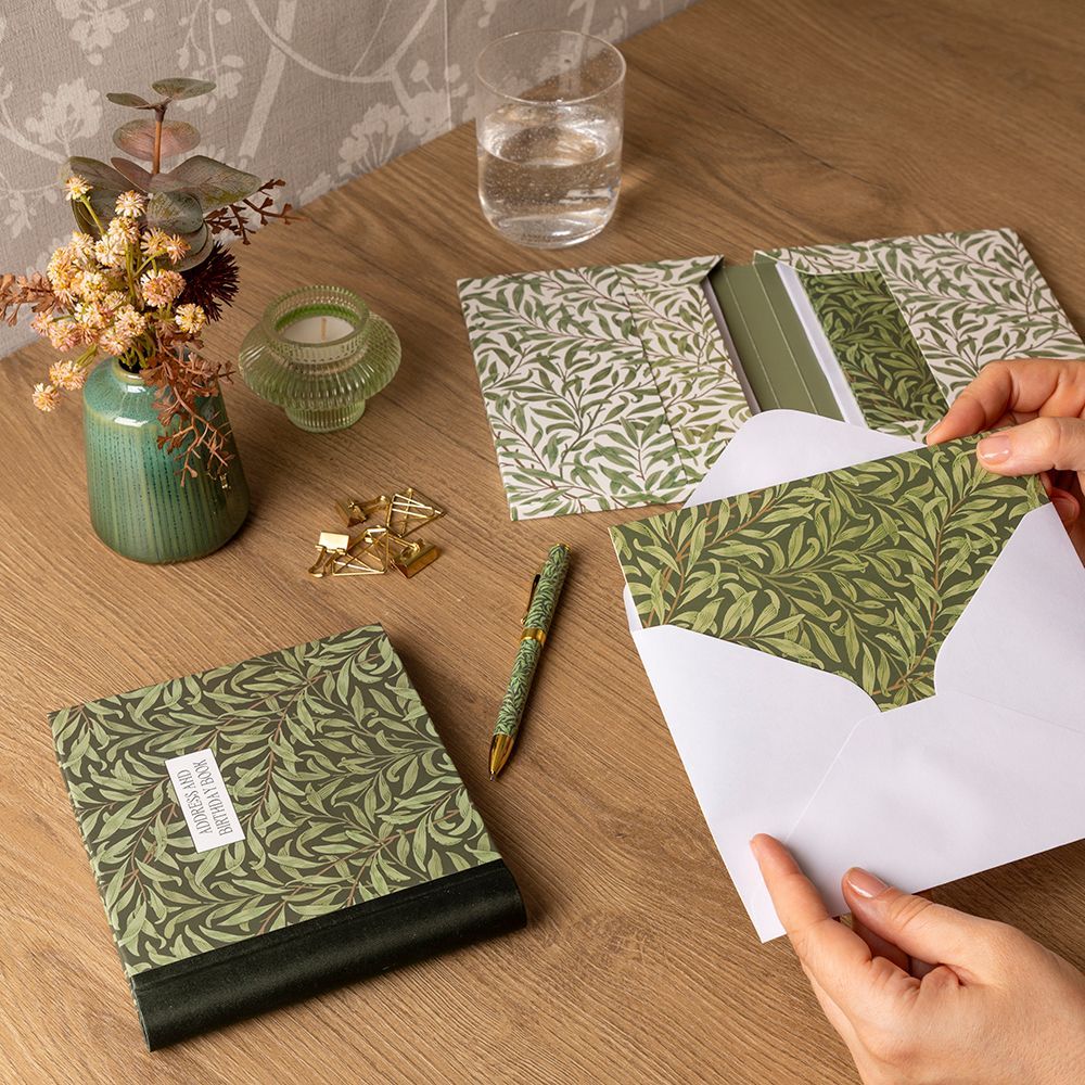 A bunch of cards are sitting on a wooden table.