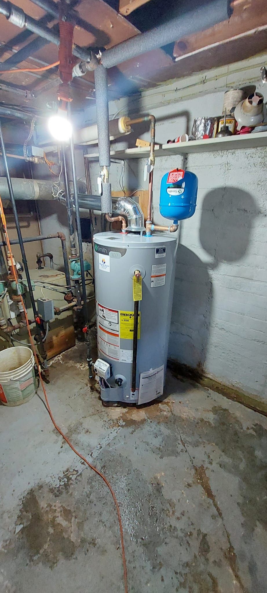 Water heater in a basement. Floor is wet.