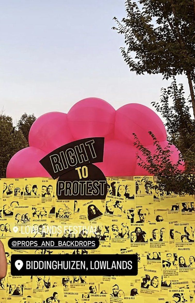 Pink balloons and protest signs at Biddinghuizen, Lowlands. Amnesty