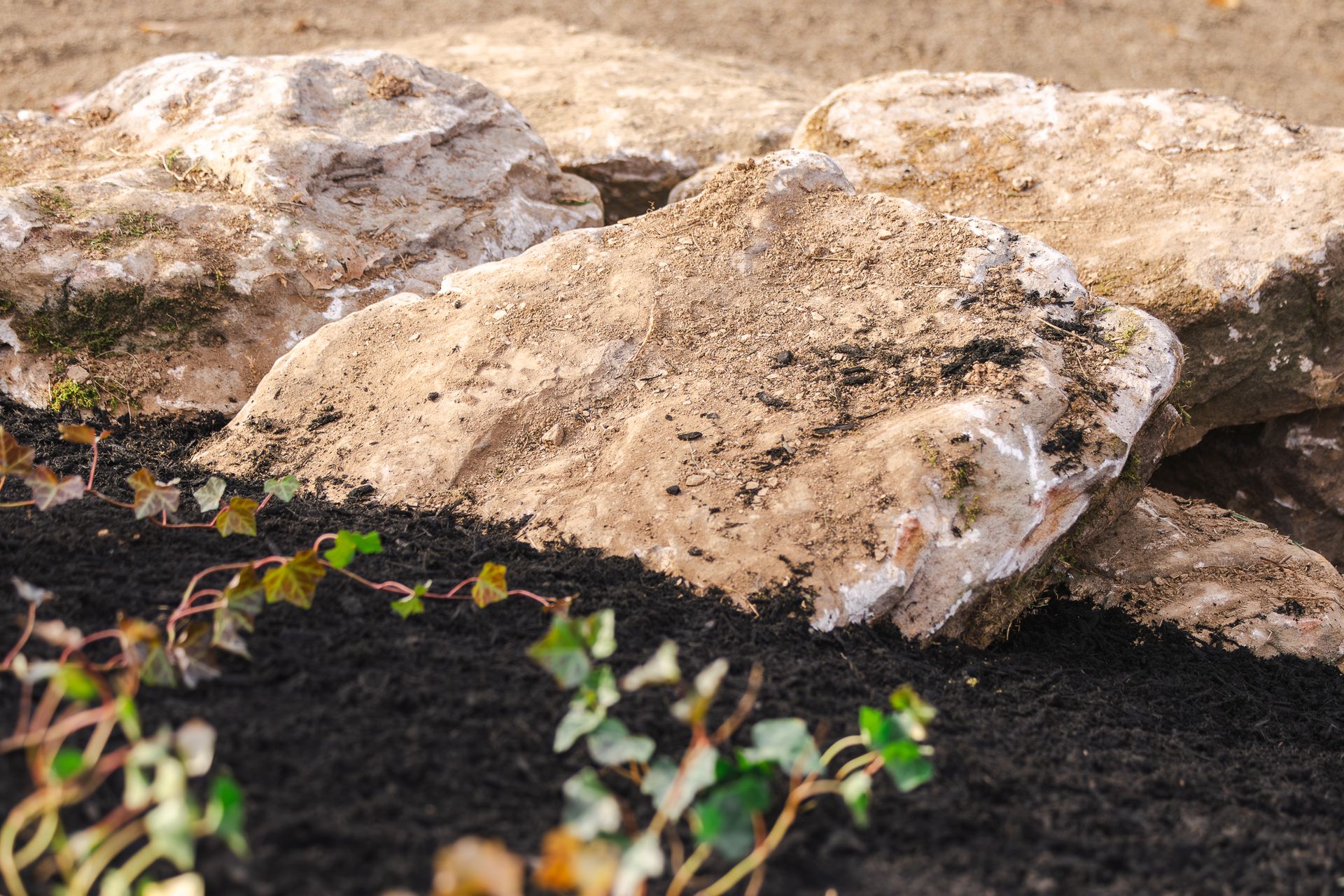A pile of rocks sitting on top of a pile of dirt.