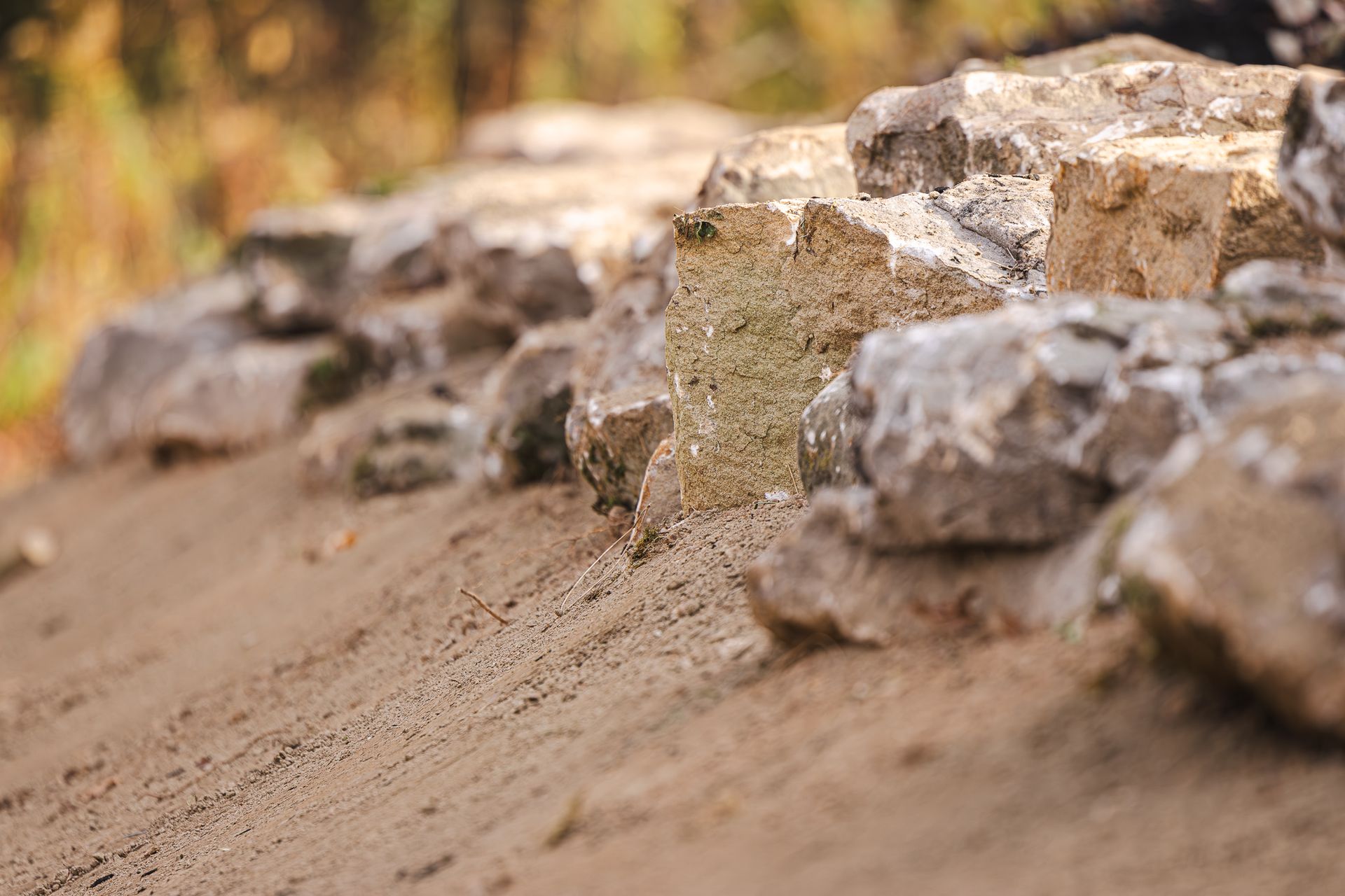 A pile of rocks sitting on top of a dirt hill.