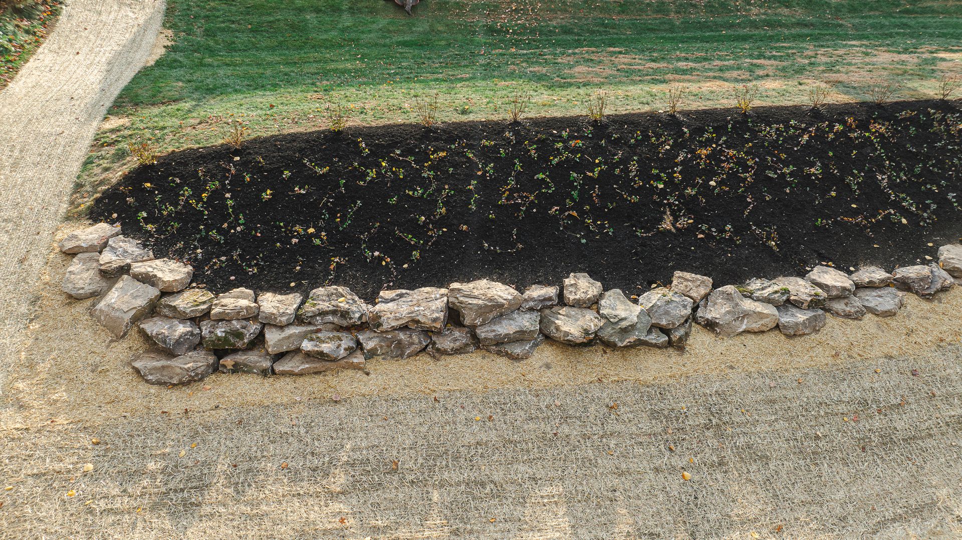 A gravel road with a stone border along the side of it