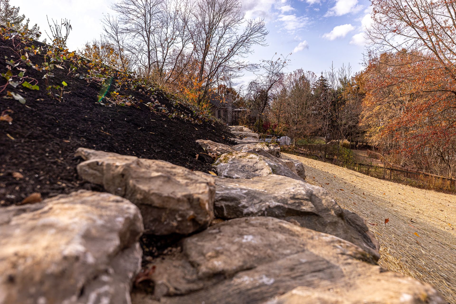 A river runs through a park surrounded by rocks and trees.