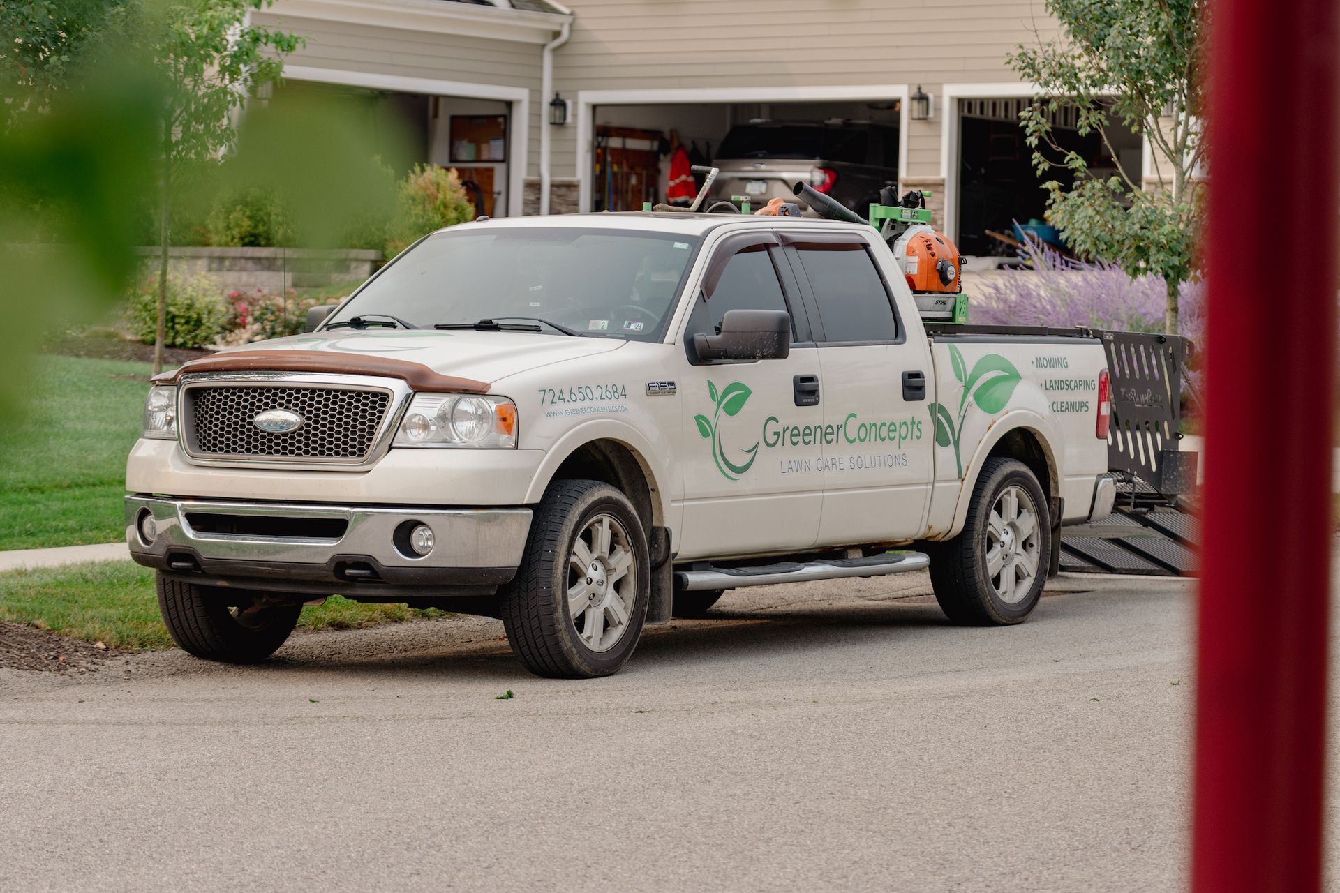A white pickup truck is parked in front of a house.