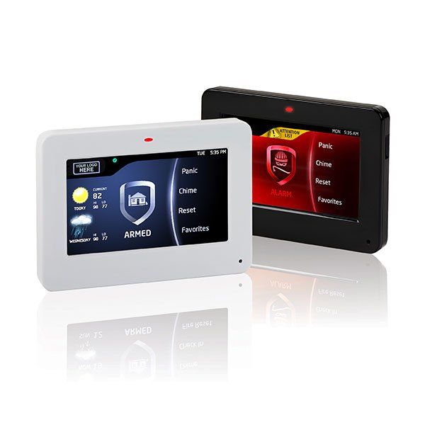 Two security systems are sitting next to each other on a table.