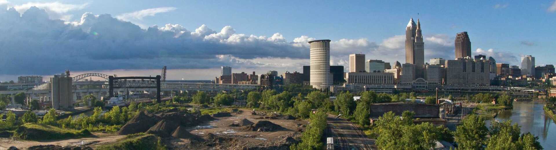An aerial view of a city skyline with a river in the foreground.