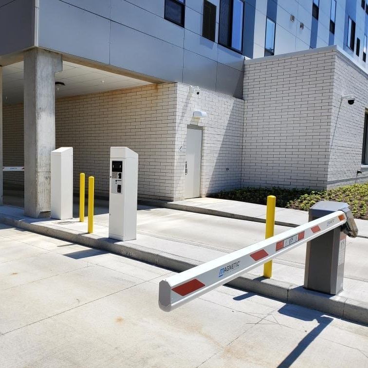 A parking lot with a barrier that says oracle on it