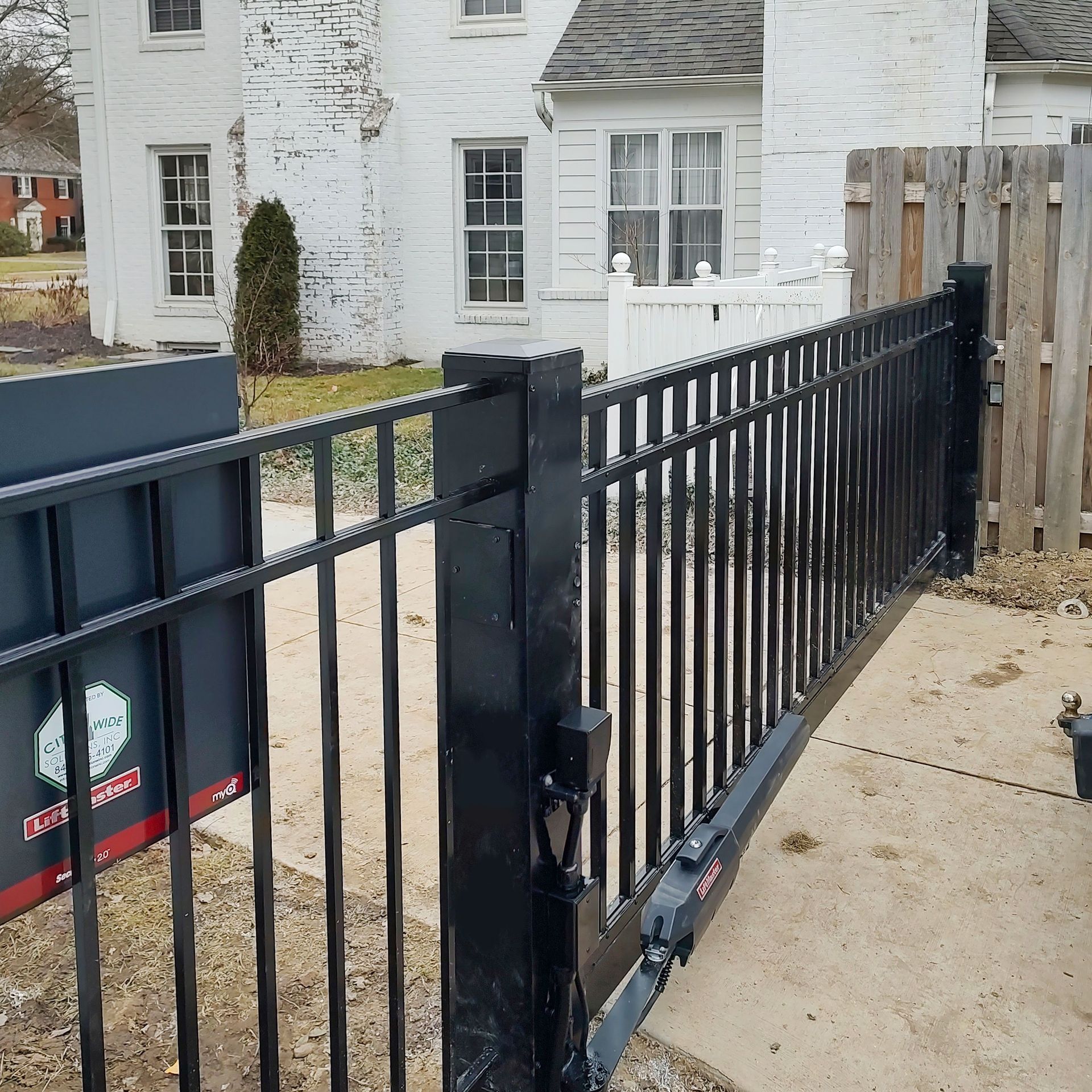 A white house with a black fence in front of it
