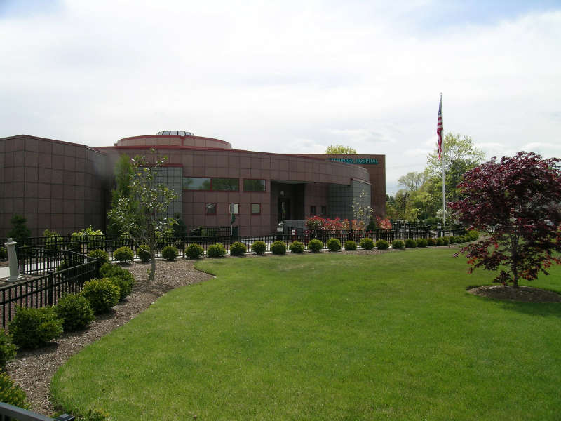 A large building with a flag in front of it