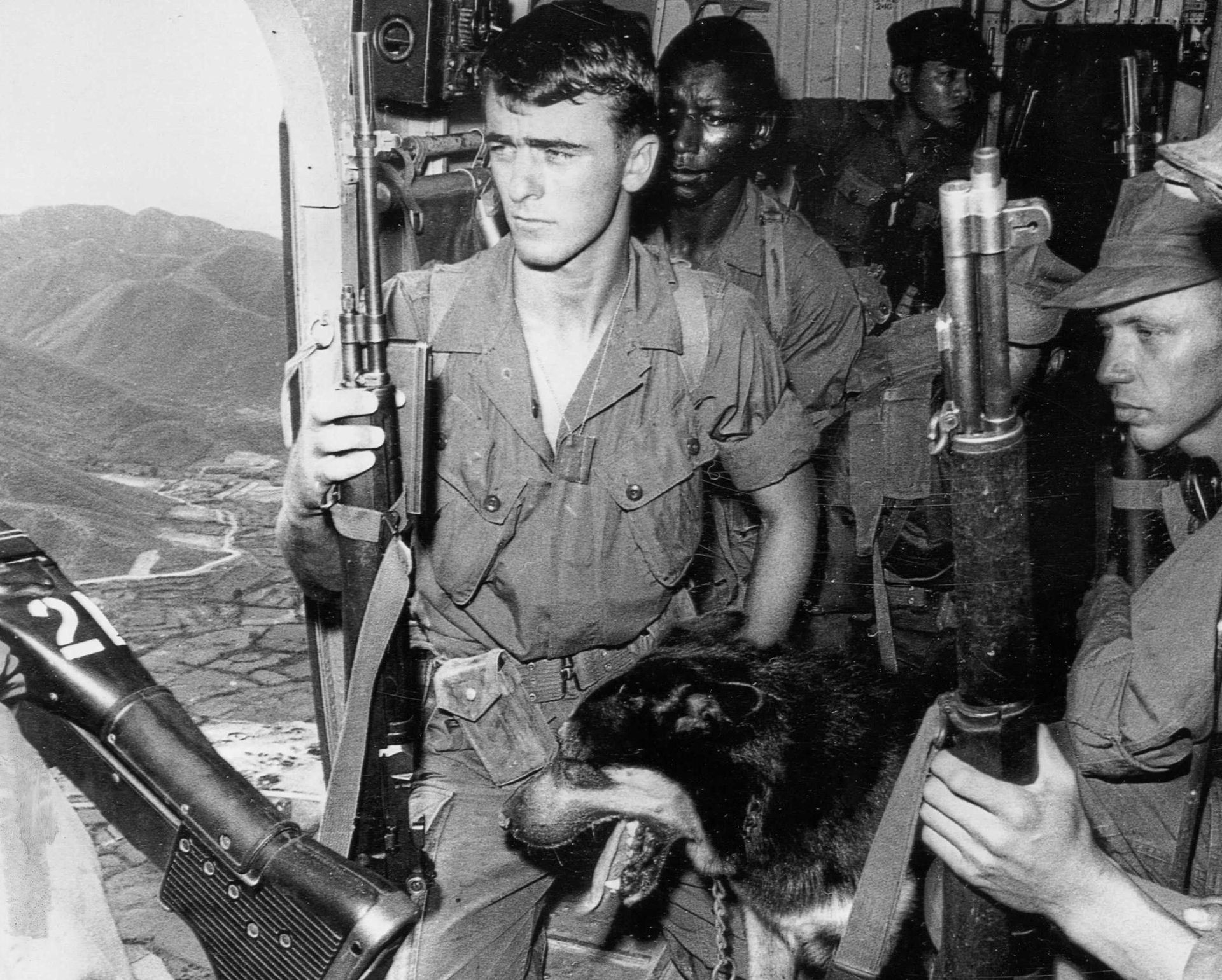 A black and white photo of soldiers with the number 27 on the bottom