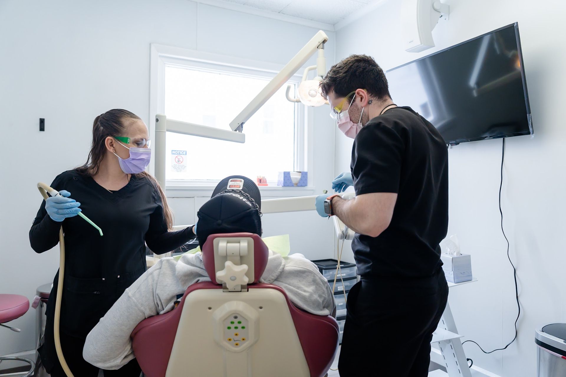 Dr. Candido and his assistant fitting a dental bridge in Rome, NY
