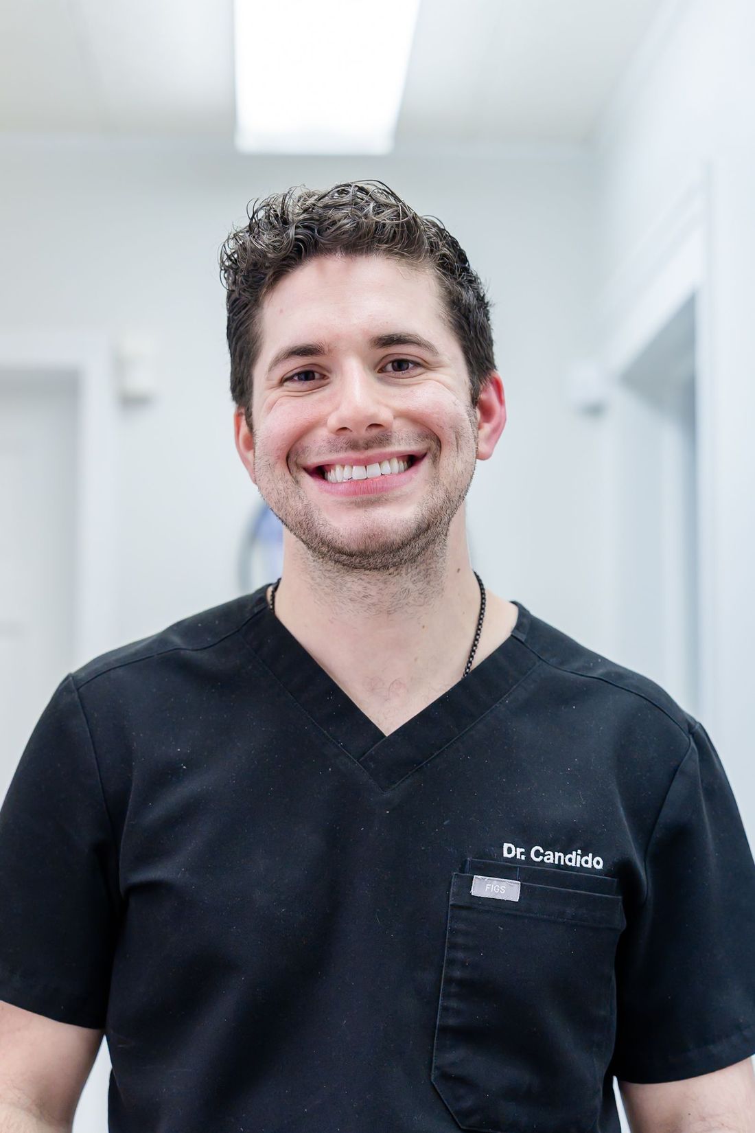 Dr. Jonathan Candido smiling in the hallway at Rome Dental & Implant Center in Rome, NY