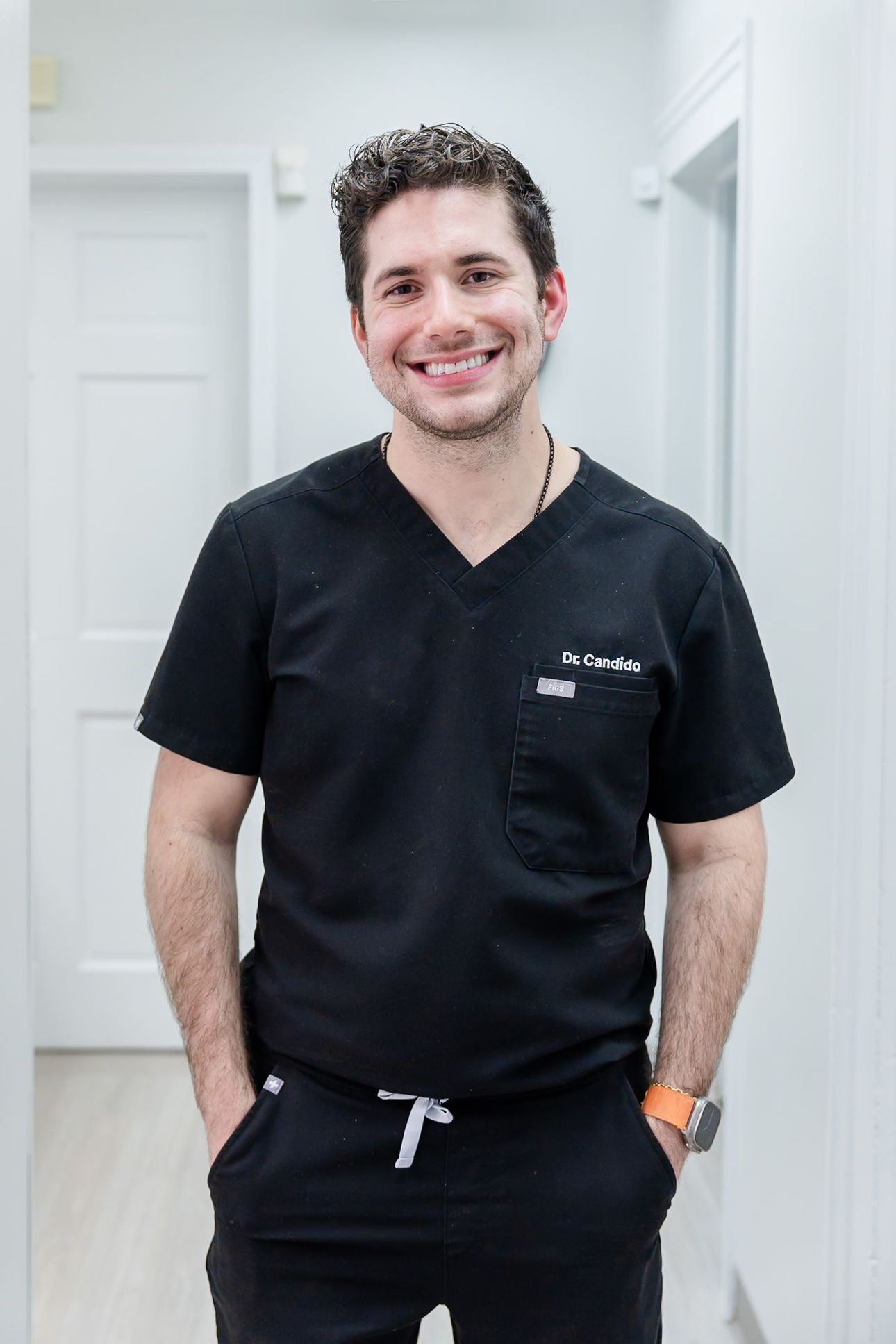 Dr. Jonathan Candido, DMD, smiling in the hallway at Rome Dental