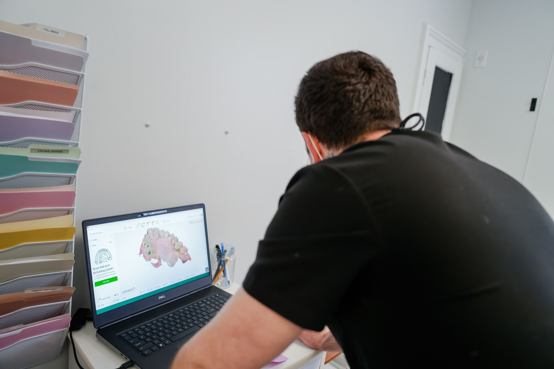 Inlays & Onlays: Dr. Candido reviewing a digital tooth scan on a laptop