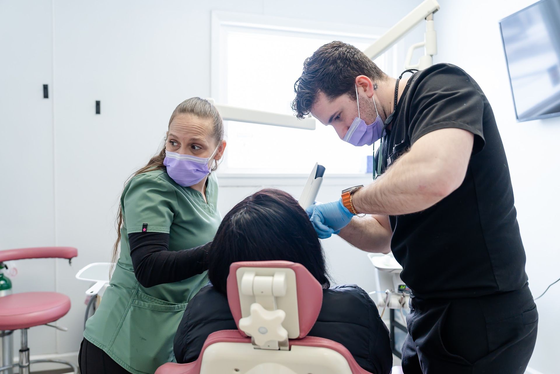 Dr. Candido and his assistant restoring a tooth at Rome Dental in Rome, NY
