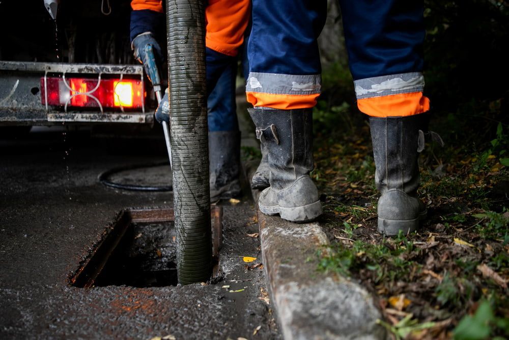 A Manhole Cover Is Being Filled With Water By A Truck — Justin Drew Plumbing in Belmont, VIC