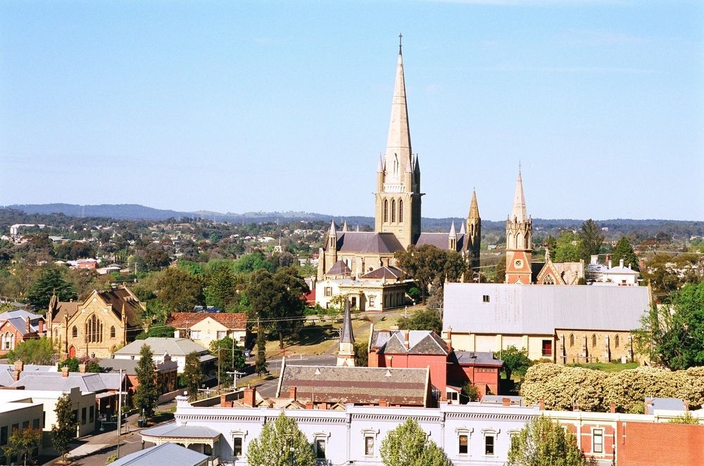 Town Skyline With a Tall Church Steeple Under a Clear Blue Sky — Justin Drew Plumbing in Geelong West, VIC