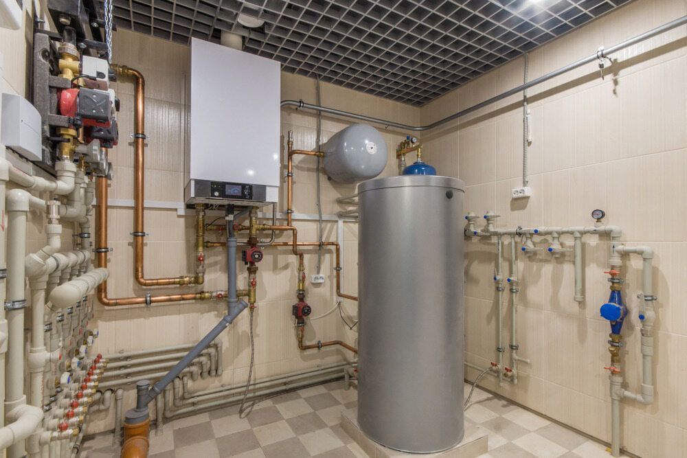 A Room With A Boiler And Pipes In It — Justin Drew Plumbing in Grovedale, VIC