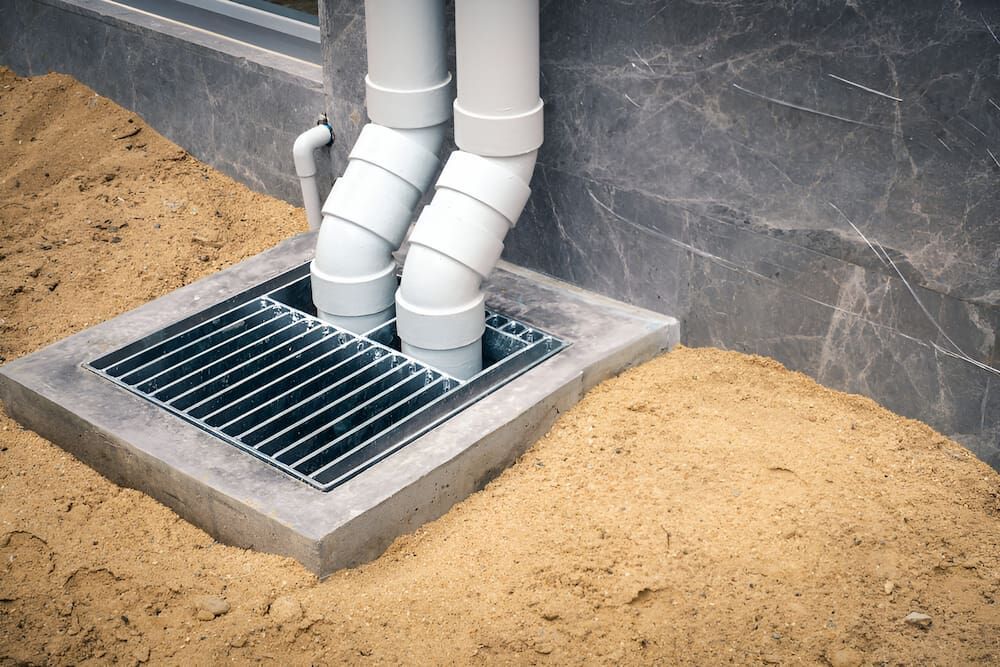 A Drainage System Is Being Installed On The Side Of A Building — Justin Drew Plumbing in Grovedale, VIC
