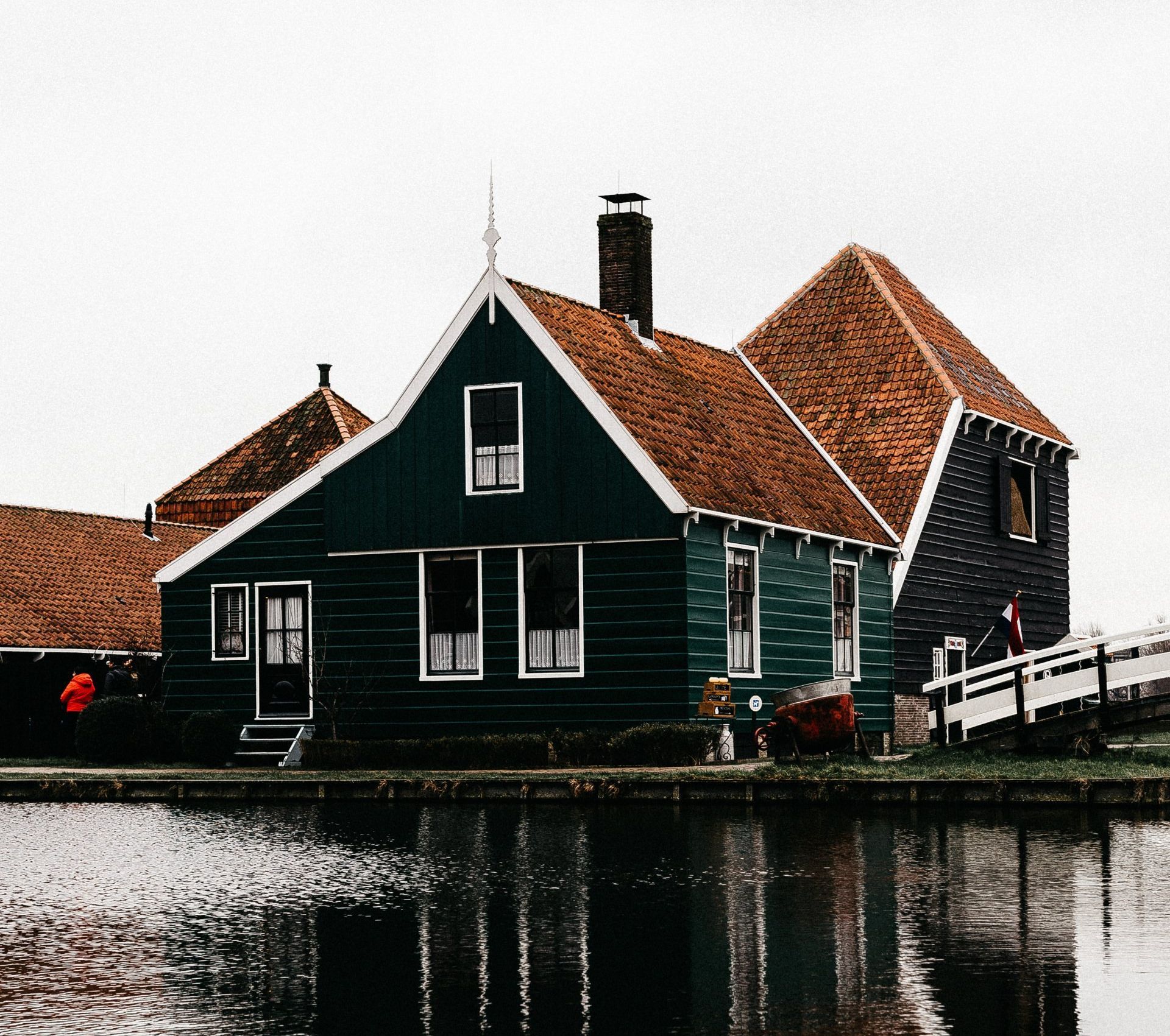 a green house next to water