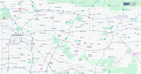 Road map with highways, towns, and green park areas across a broad region.