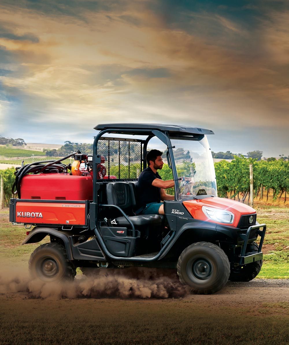 Man Riding a Kubota RTV-X900 — Machinery Sells In Dorrigo, NSW