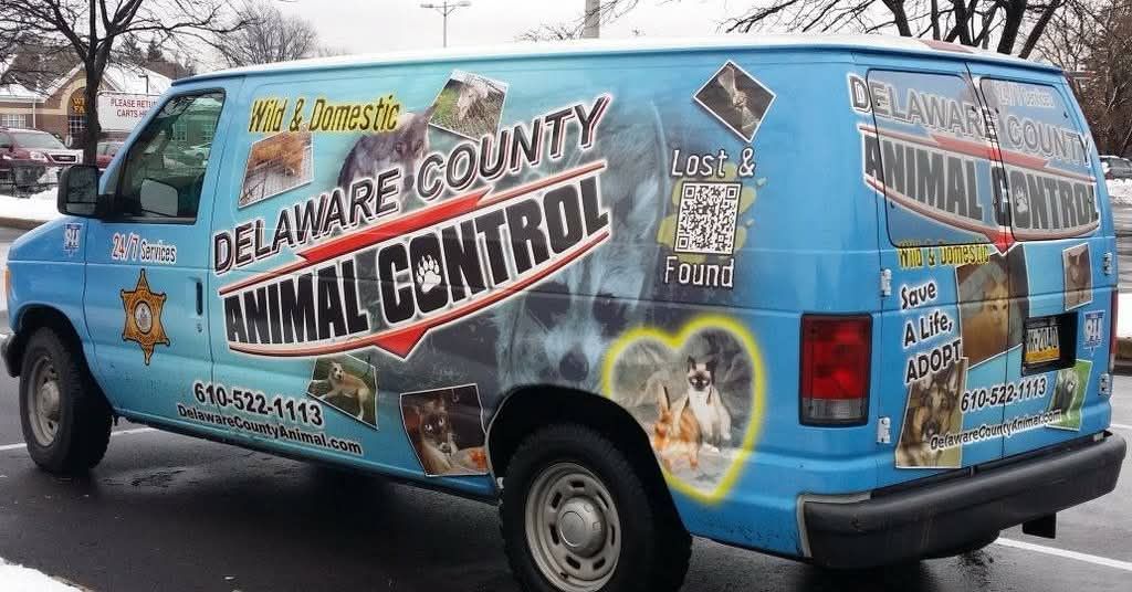 Blue Delaware County Animal Control van with animal graphics.