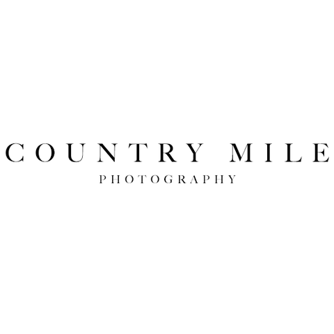 The logo for country mile photography is black and white.