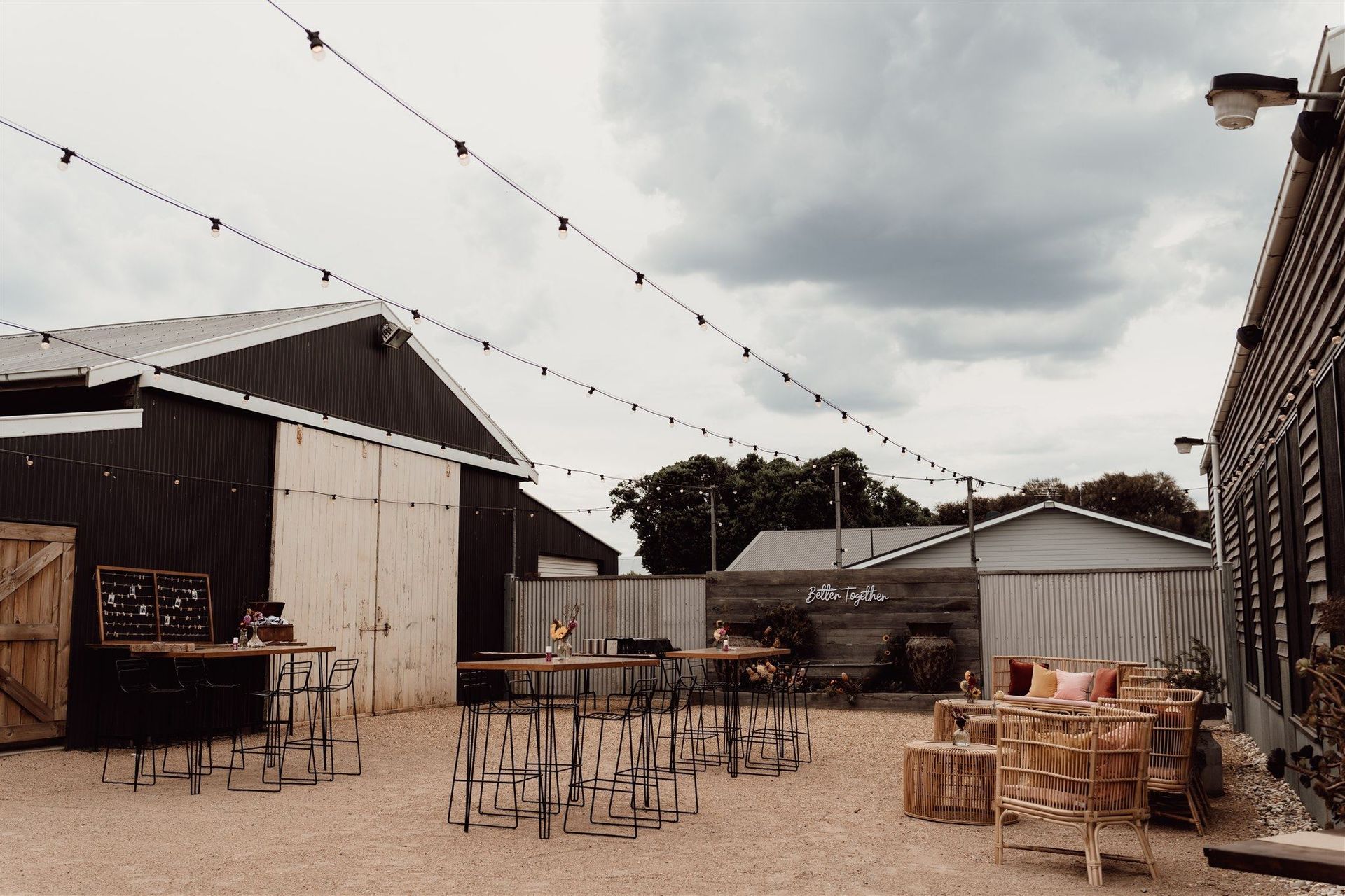 A row of tables and chairs are lined up in front of a building.