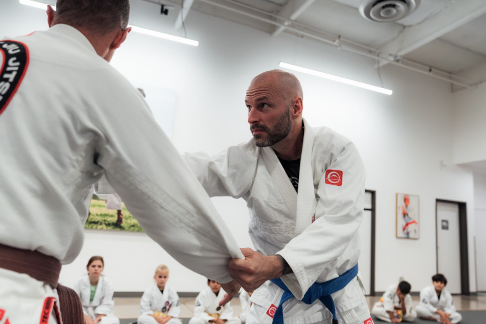Adults practicing martial arts drills at Champion Martial Arts & Fitness in Pasadena, TX for stress.