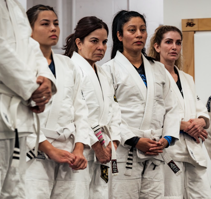 Adults practicing partner drills at Champion Martial Arts & Fitness in Pasadena, TX.