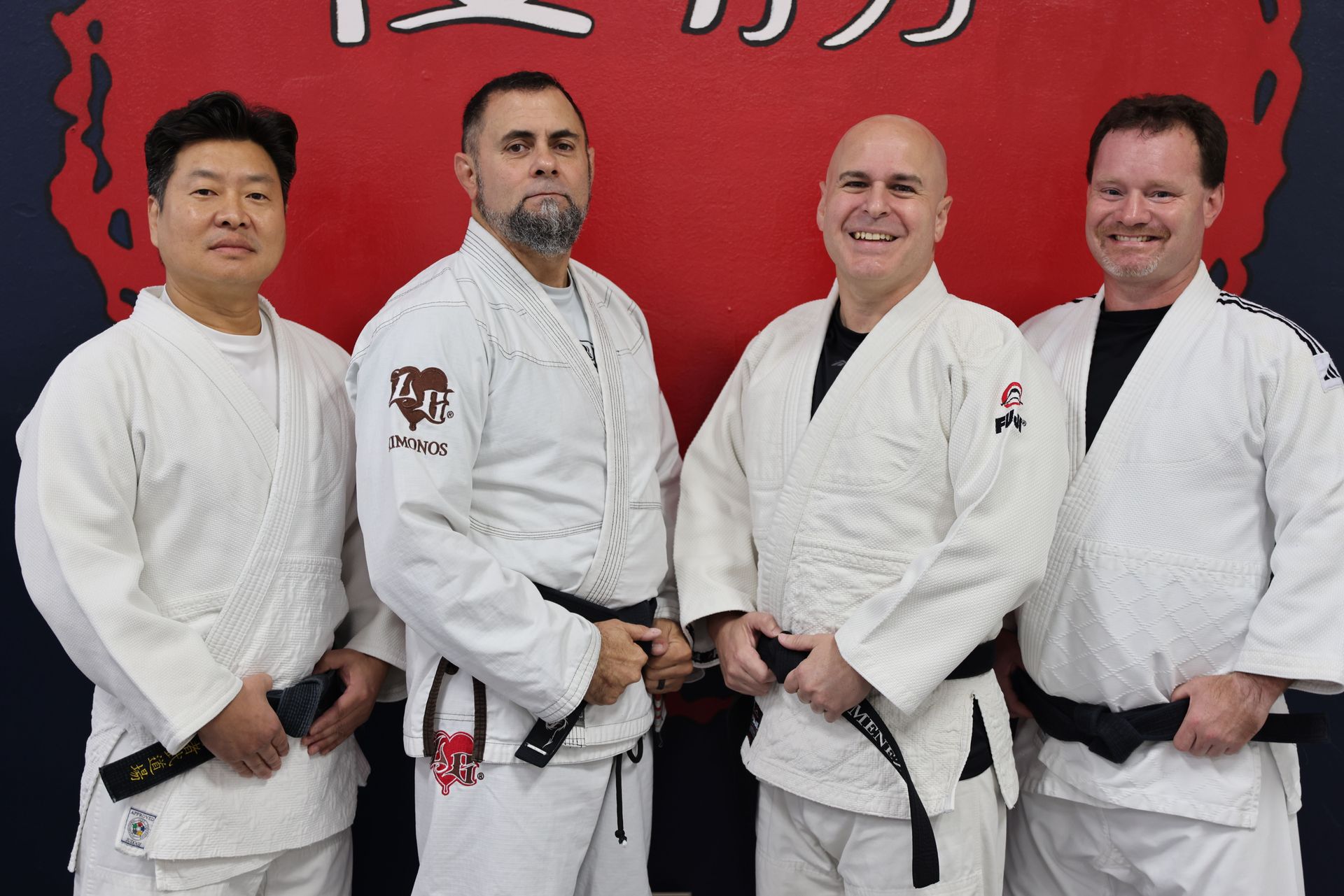 Adult judo students practicing safe breakfalls at Champion Martial Arts & Fitness in Pasadena, TX.