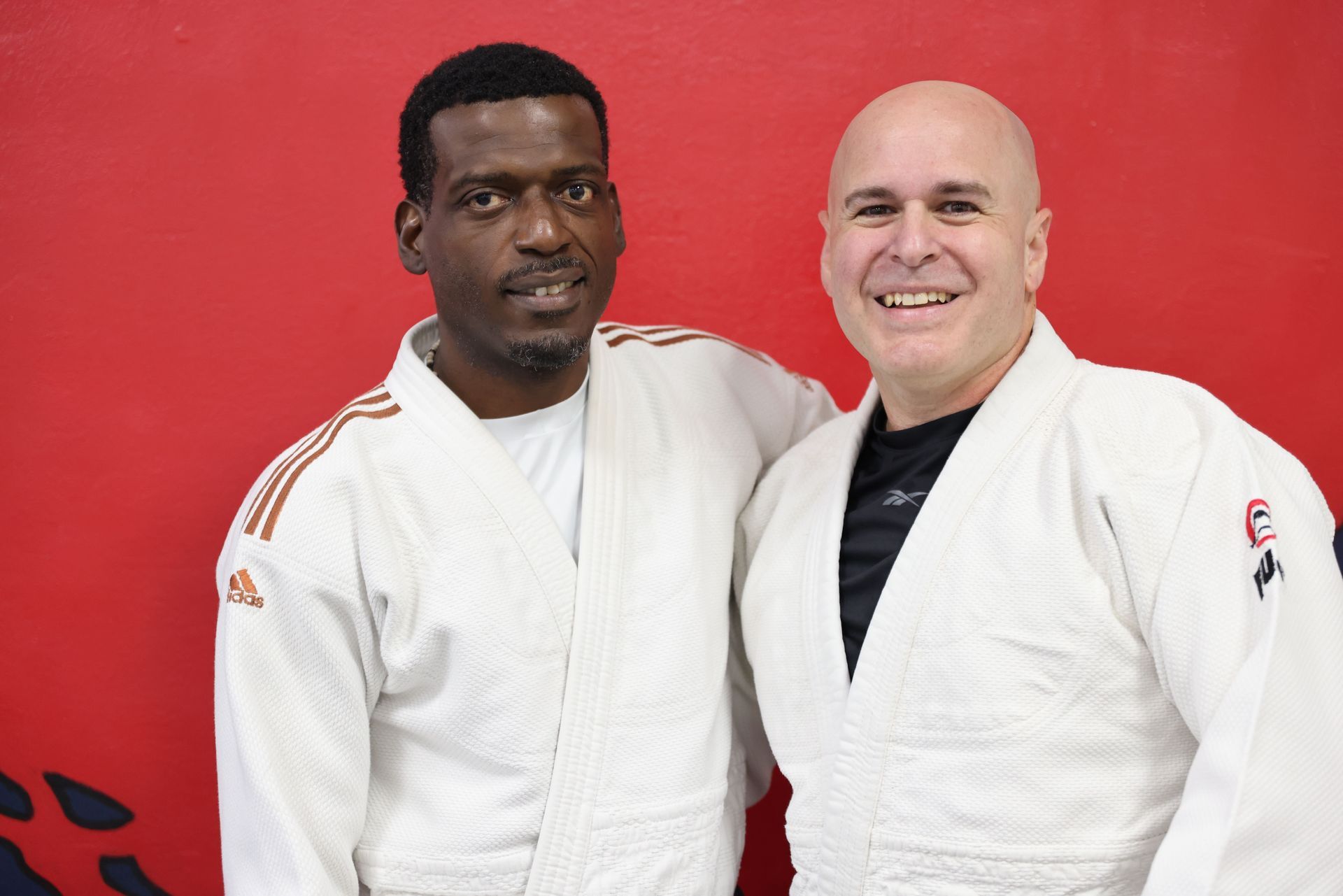 Adults practice judo throws and safe breakfalls at Champion Martial Arts & Fitness in Pasadena, TX for strength and stress relief.