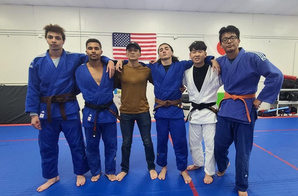 Adults practicing judo throws and breakfalls at Champion Martial Arts & Fitness in Pasadena, TX.