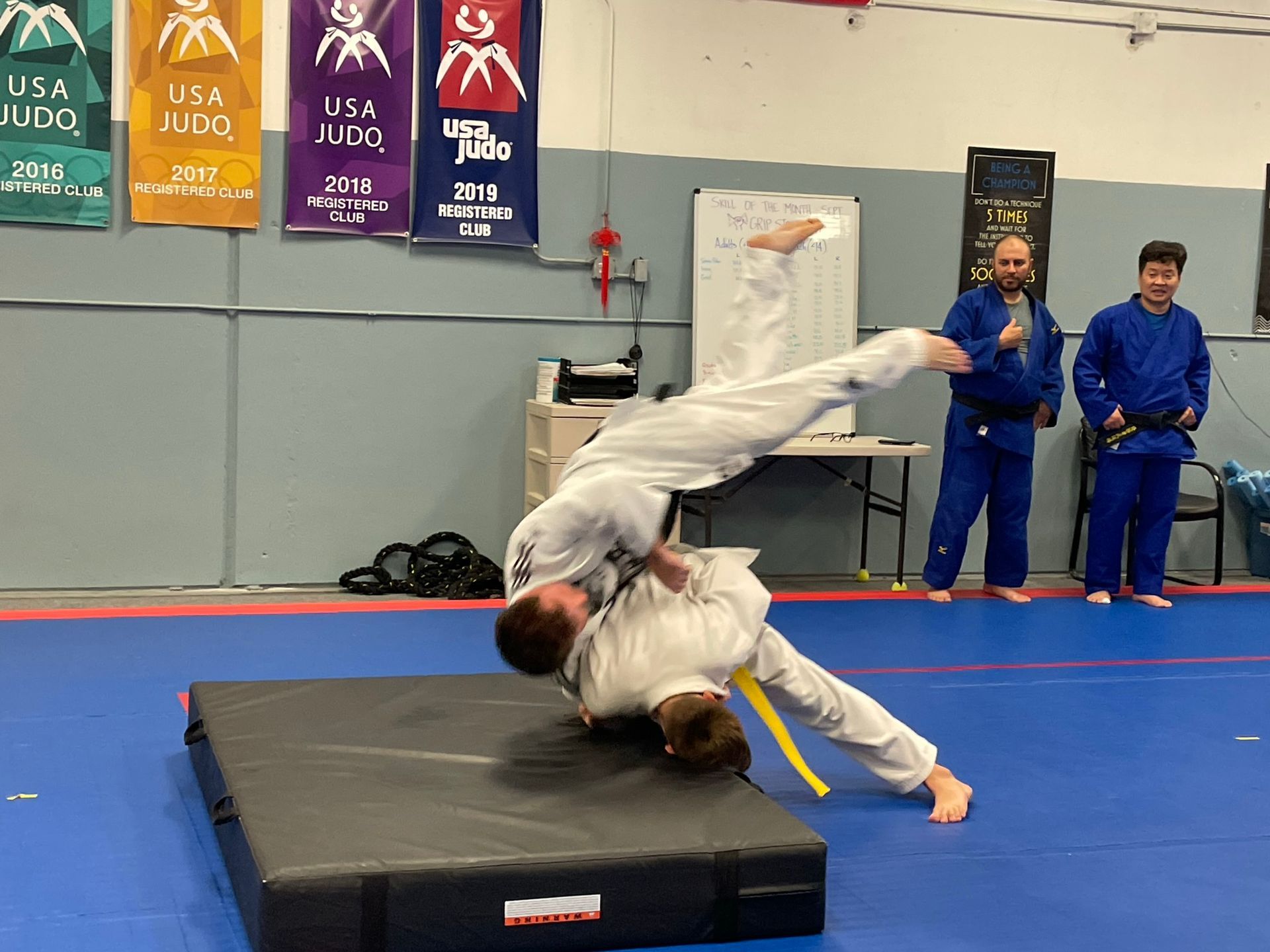 Beginner students practice safe judo throws on mats at Champion Martial Arts & Fitness in Pasadena, TX for confidence.