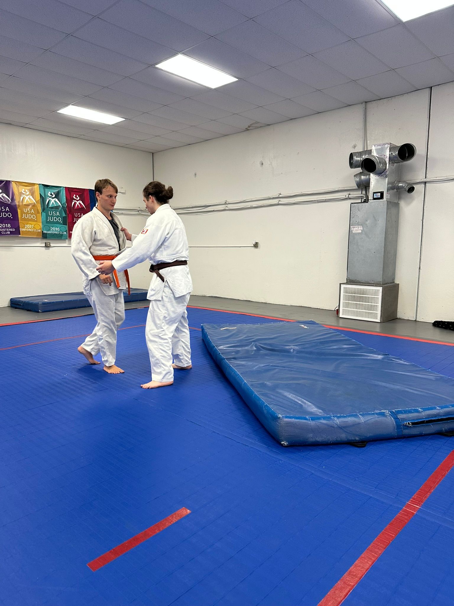 Kids and adults practice safe Judo breakfalls at Champion Martial Arts & Fitness in Pasadena, TX for confidence.