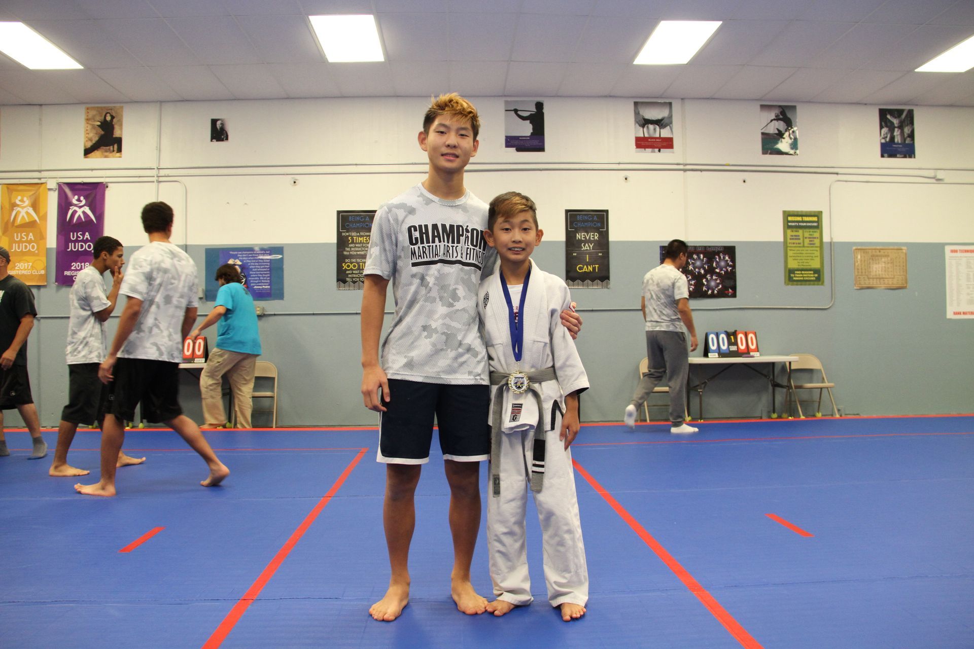 Kids and adults practicing Judo partner drills at Champion Martial Arts & Fitness in Pasadena, TX to build teamwork.