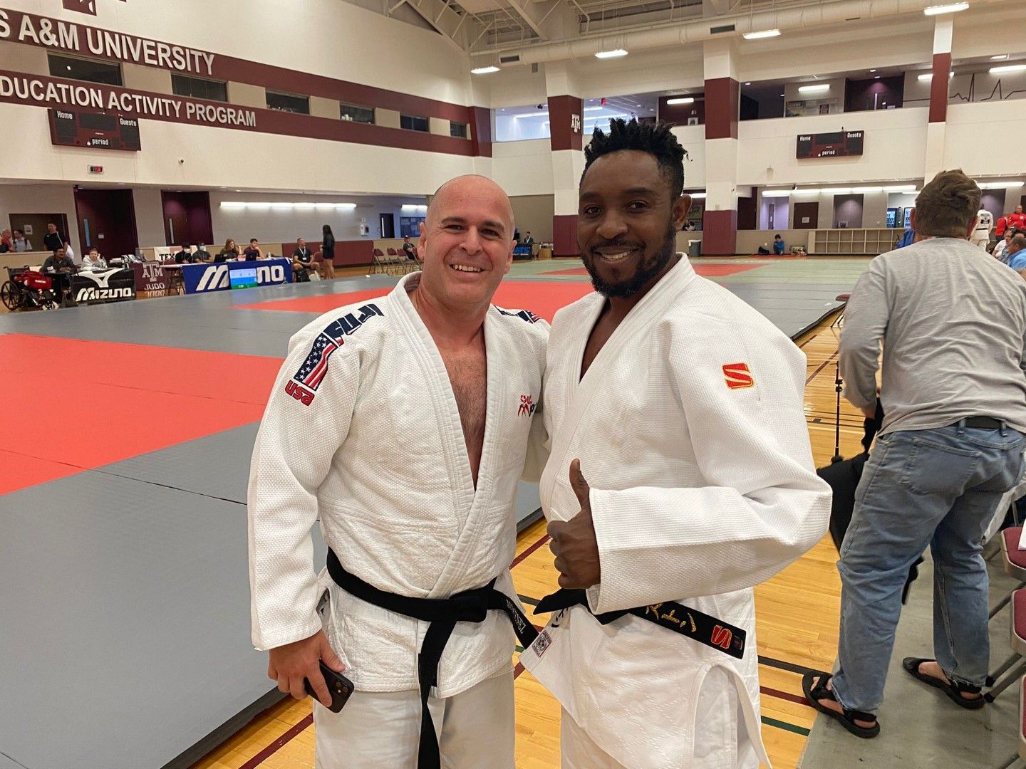 Training partners practice safe throws and breakfalls at Champion Martial Arts & Fitness in Pasadena, TX, building support.