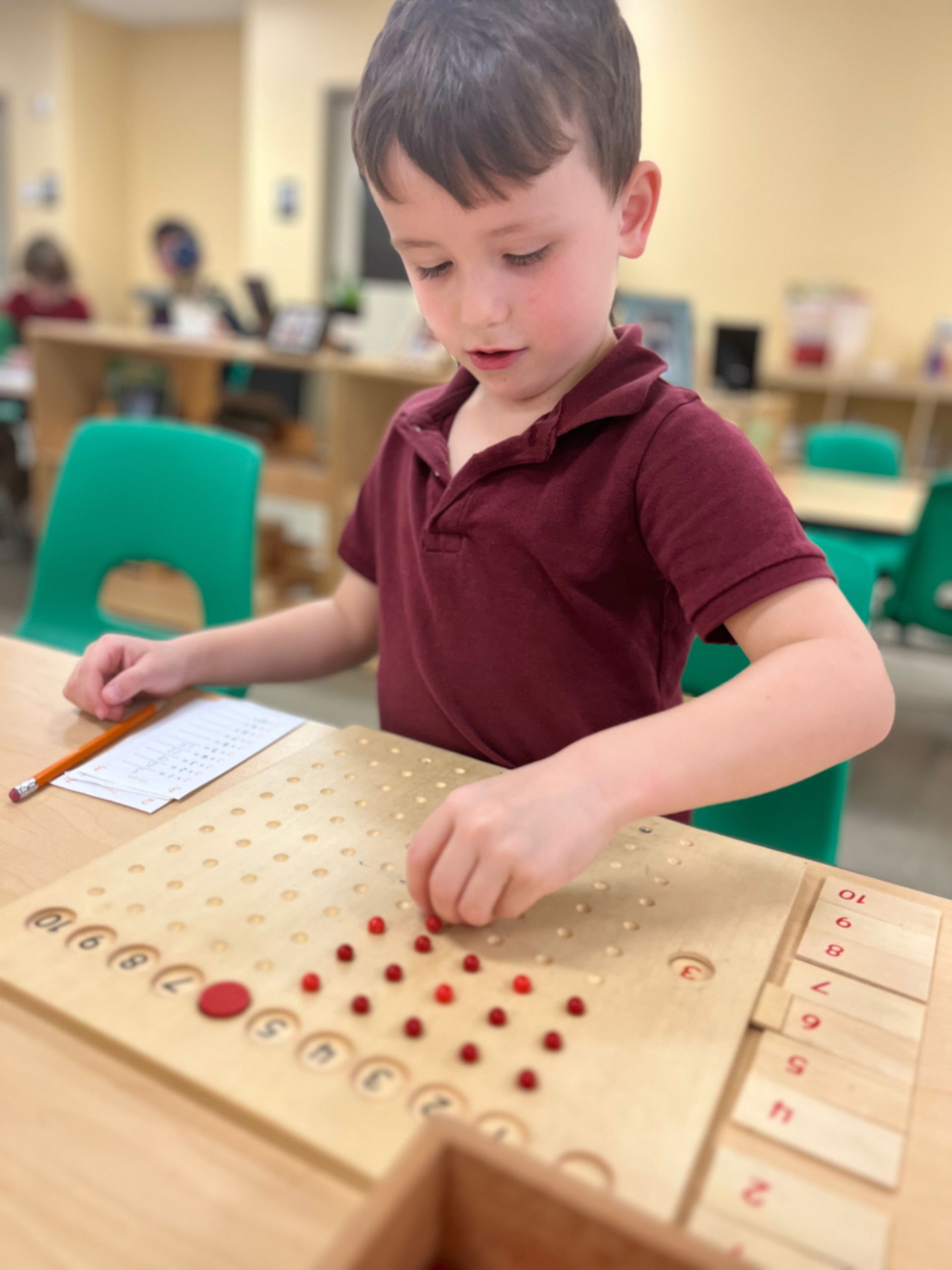 montessori child working with beads activity