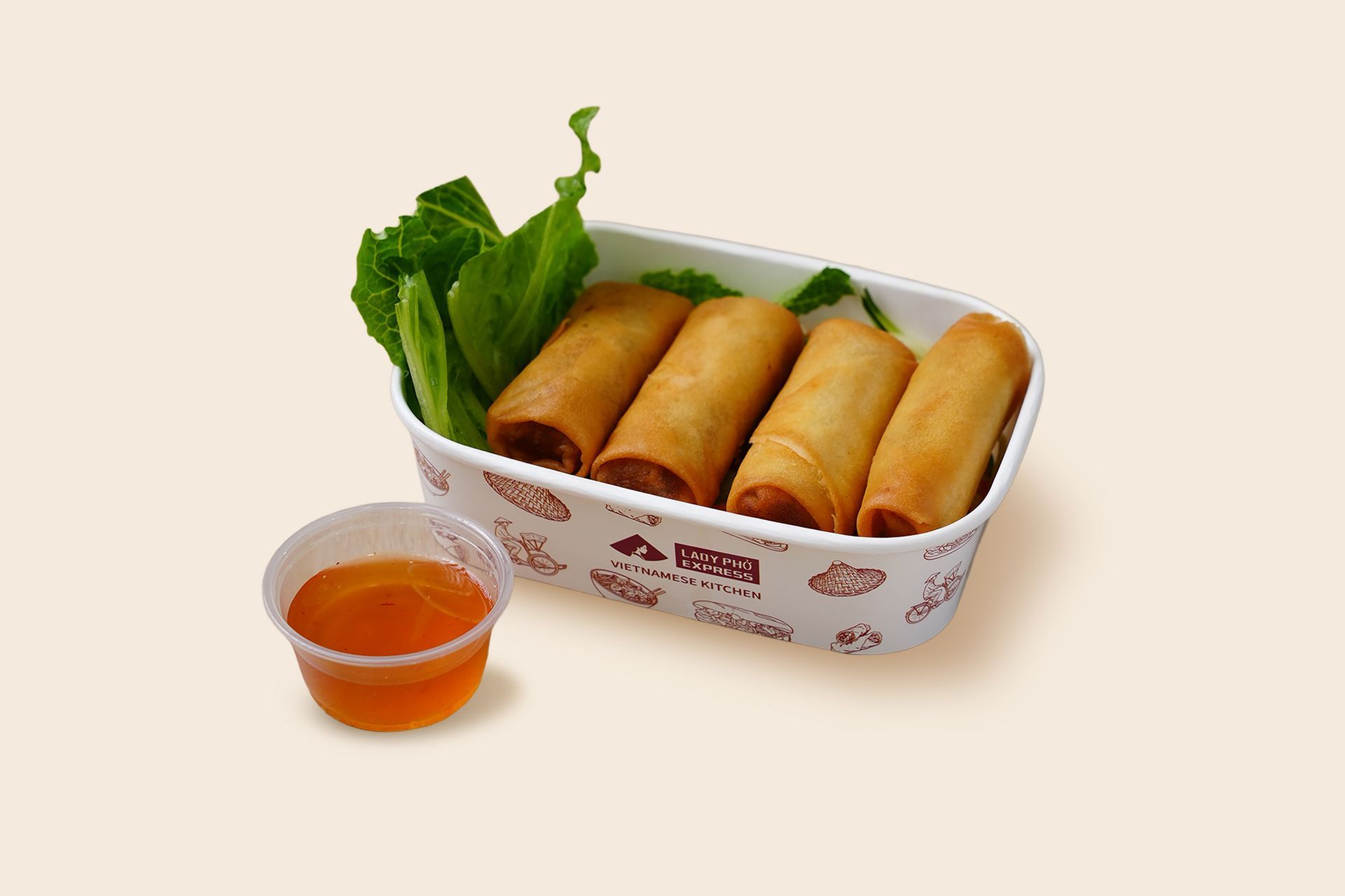 Takeout box with four spring rolls and dipping sauce on a light background