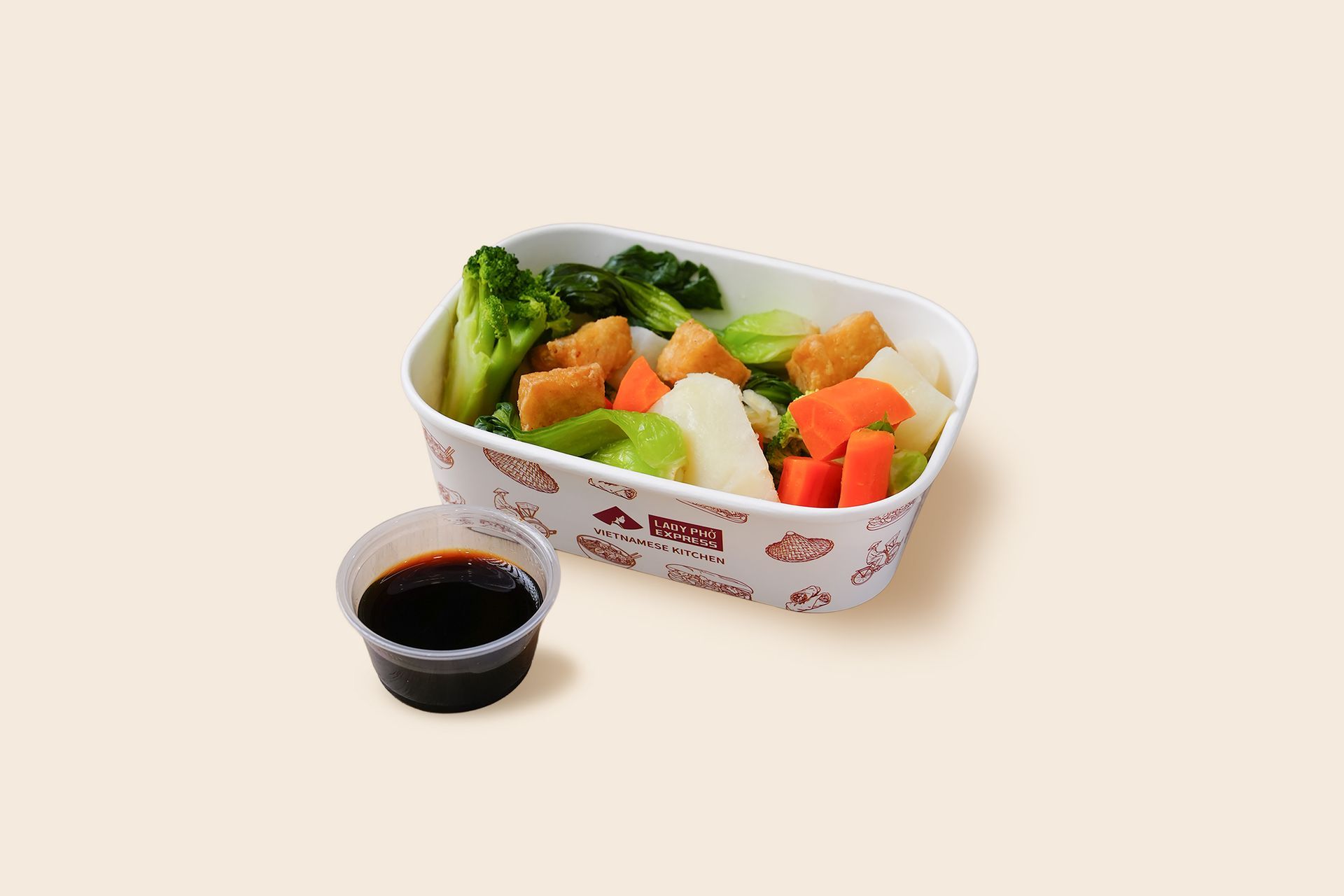Takeout tray with mixed vegetable stir-fry and a cup of soy sauce