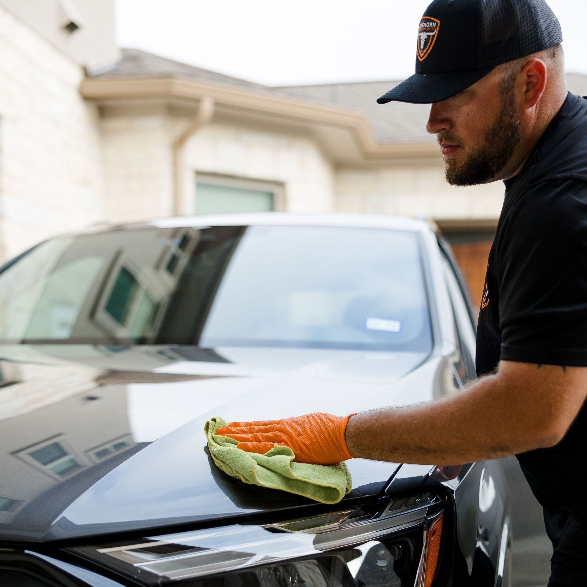 Get professional mobile car detailing in Austin, TX. Wiping top of car after mobile car detailing in Austin, TX.
