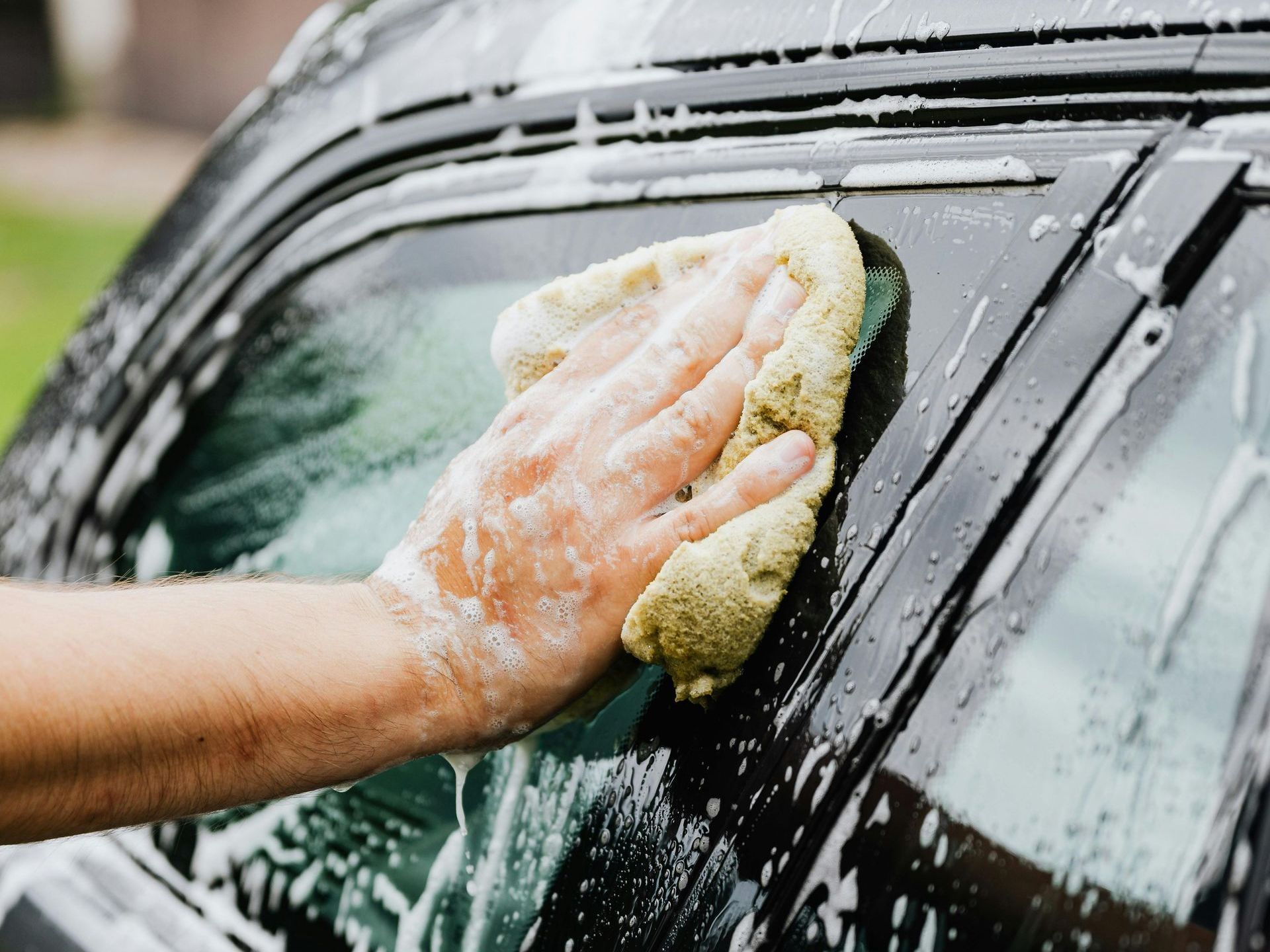 First we wash your vehicle for a clean base before ceramic coating begins. Washing outside of car with mobile detailing services near West Lake Hills TX