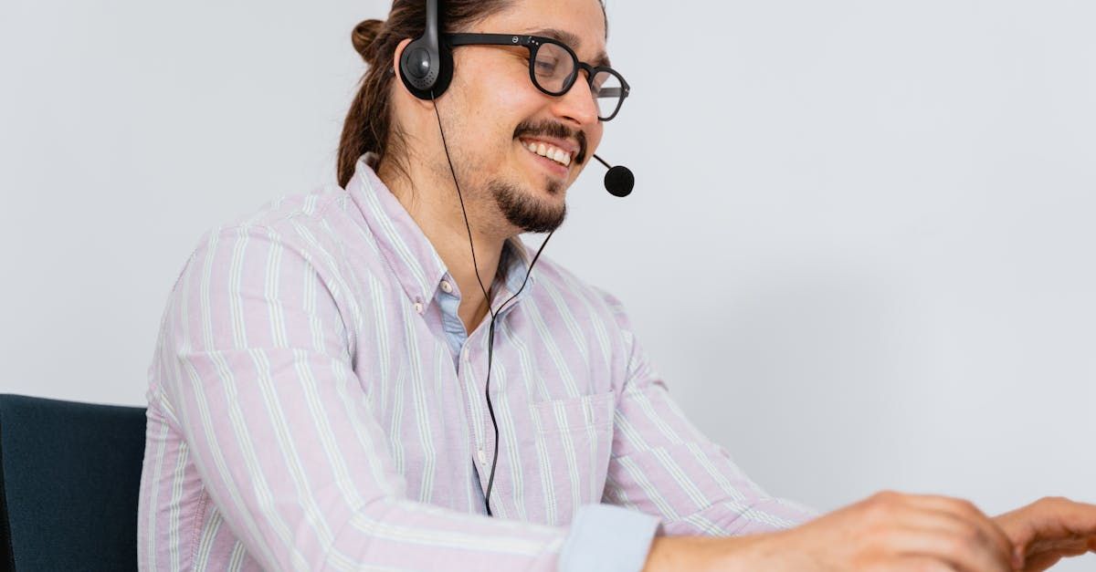 Fleet operation efficiency with mobile detailing near Buda TX man smiling with headset on and working on computer | Customer service for mobile detailing in Buda TX