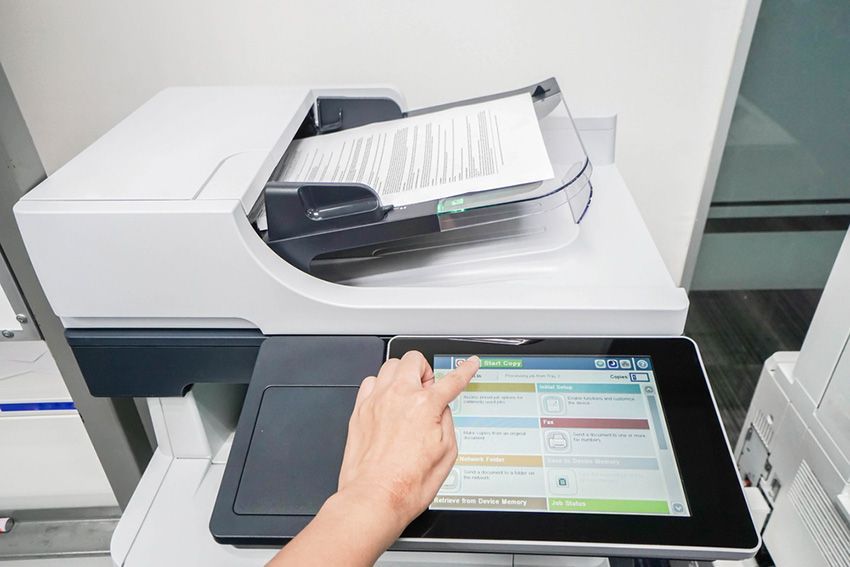 A Person is Using a Tablet to Operate a Printer — Ardent Office Equipment in Ingham, QLD