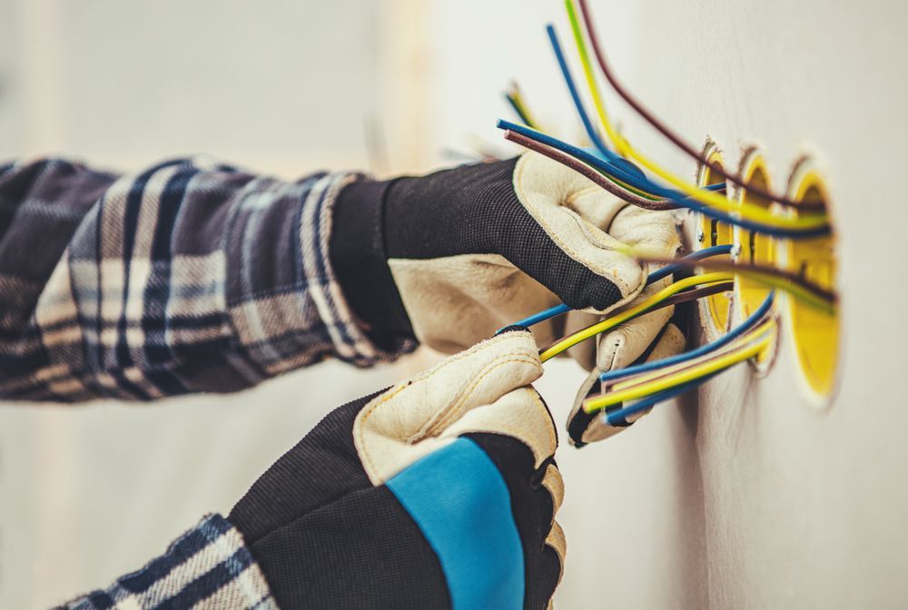 Electrician Installing Lightbulb — Premium Electrical Solutions In Elliott Heads, QLD