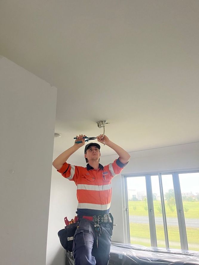 Electricians Examines Cable Connection In The Electrical Line — Premium Electrical Solutions in Bundaberg, QLD