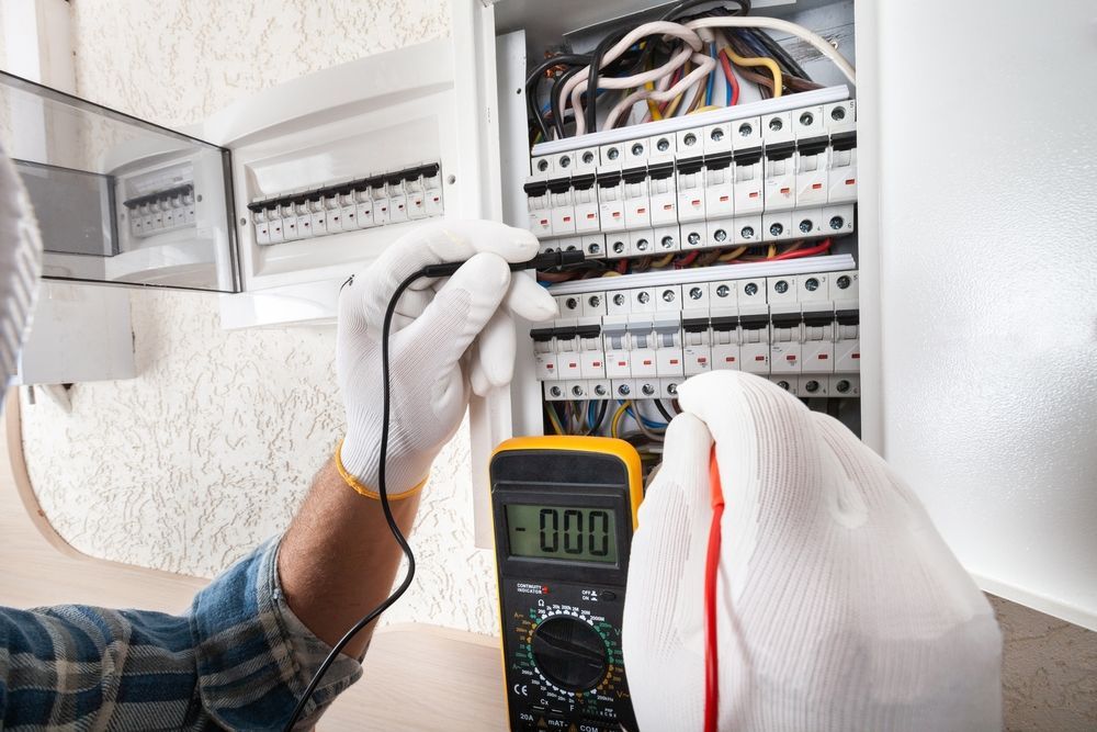 Technician Testing Electrical Breaker Panel with Multimeter and Probe Wires — Premium Electrical Solutions In Coral Cove, QLD