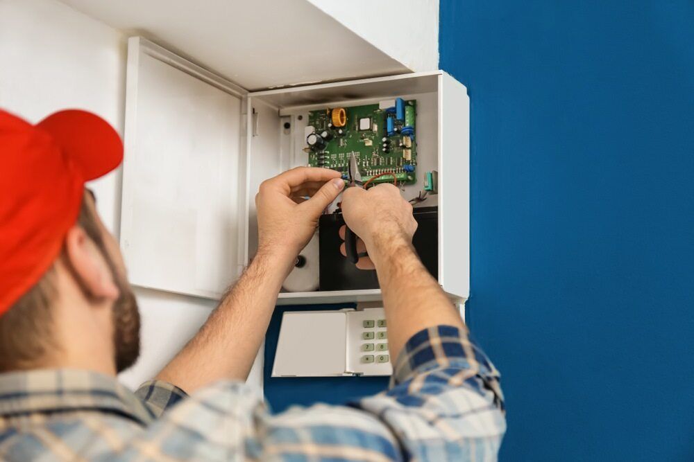 Electrician Fixing Wires On Electric Box — Premium Electrical Solutions in Bundaberg, QLD